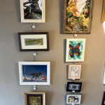 A photo of paintings hanging on the walls at the School House arts Center